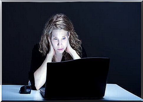 Sad woman looking at computer screen