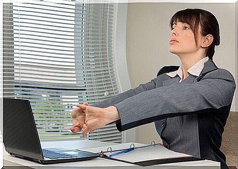 Woman performing hand exercises at work