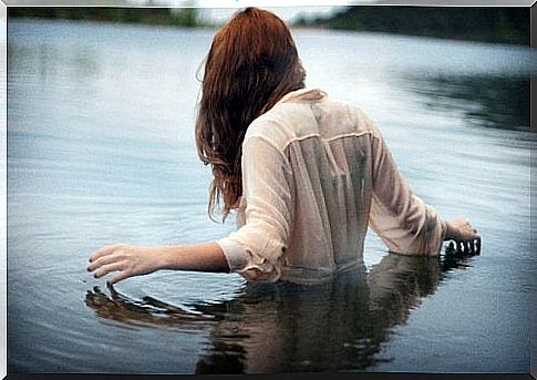 Women stand in deep water