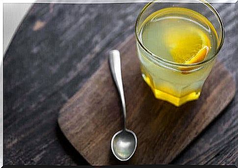 Lemon water and a spoon on a table