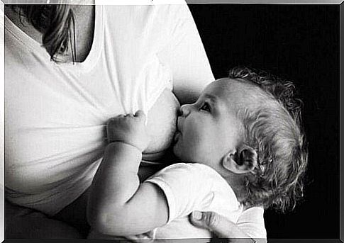 A black and white picture of a mother breastfeeding.