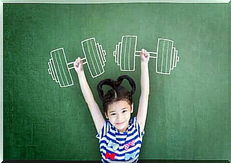 A little girl pretending to lift weights.