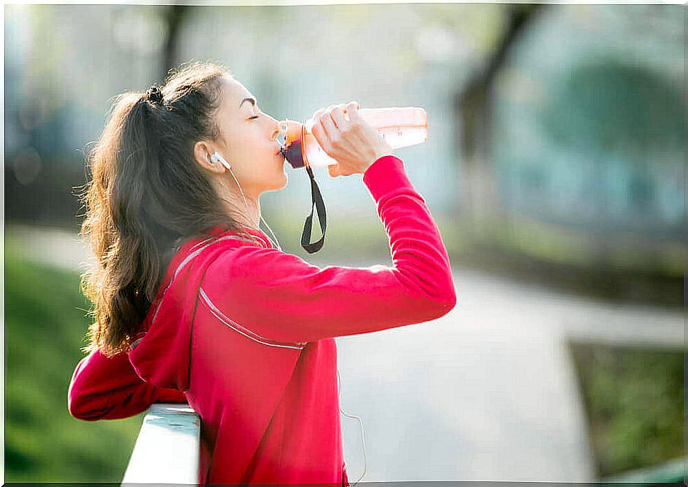 Woman drinking energy drink after exercise