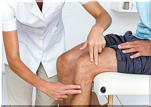 A man checking his knee with the doctor