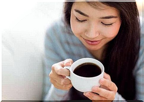 A woman drinking a cup of coffee.