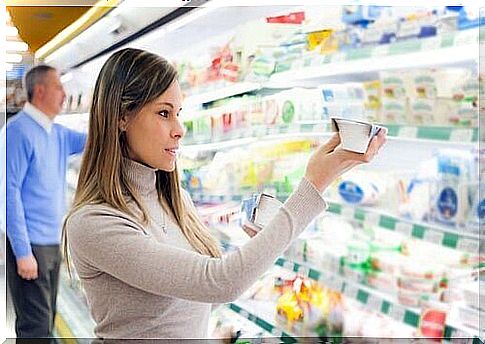 Woman looking at expiration date