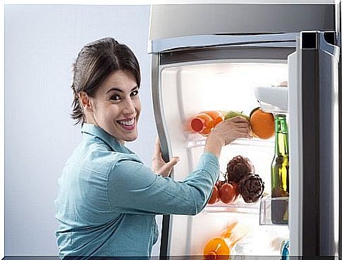 Woman storing food in refrigerator