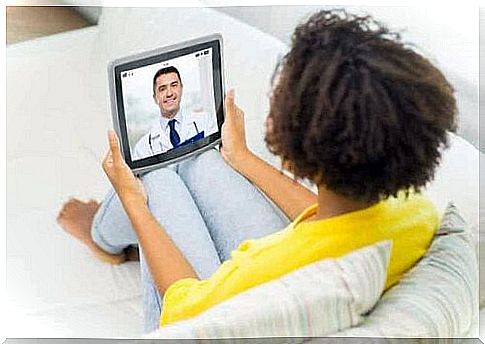 A woman talking to her online therapist on a tablet.