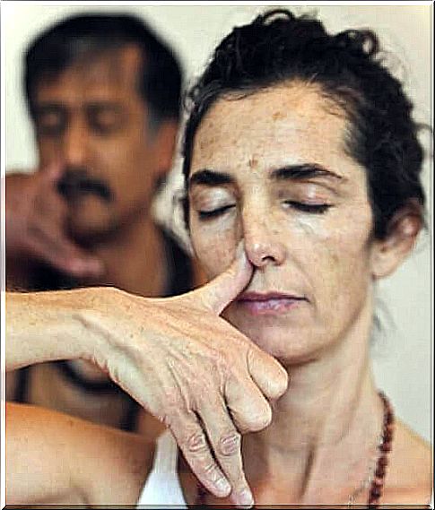 Woman holding one nostril