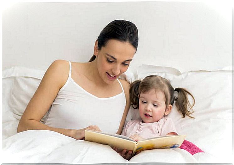 Mother and child reading in bed