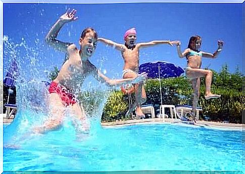 Three children jumping in a pool, they do not seem to be overloaded with activities.