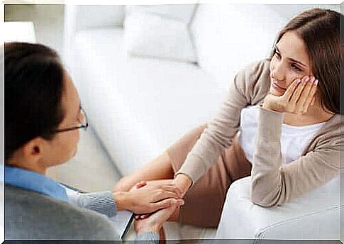 Woman holding hands with a therapist